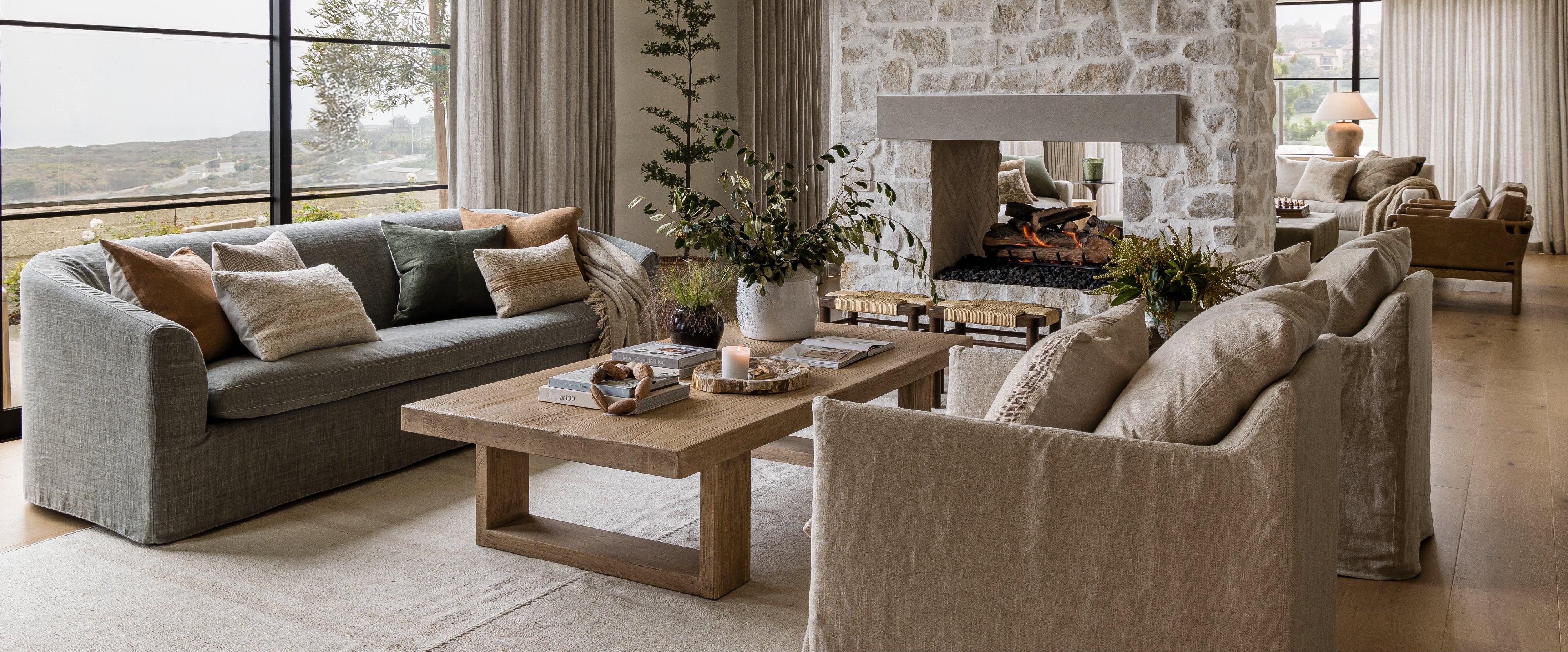 A photo of a living room with sofa, coffee table, and arm chairs