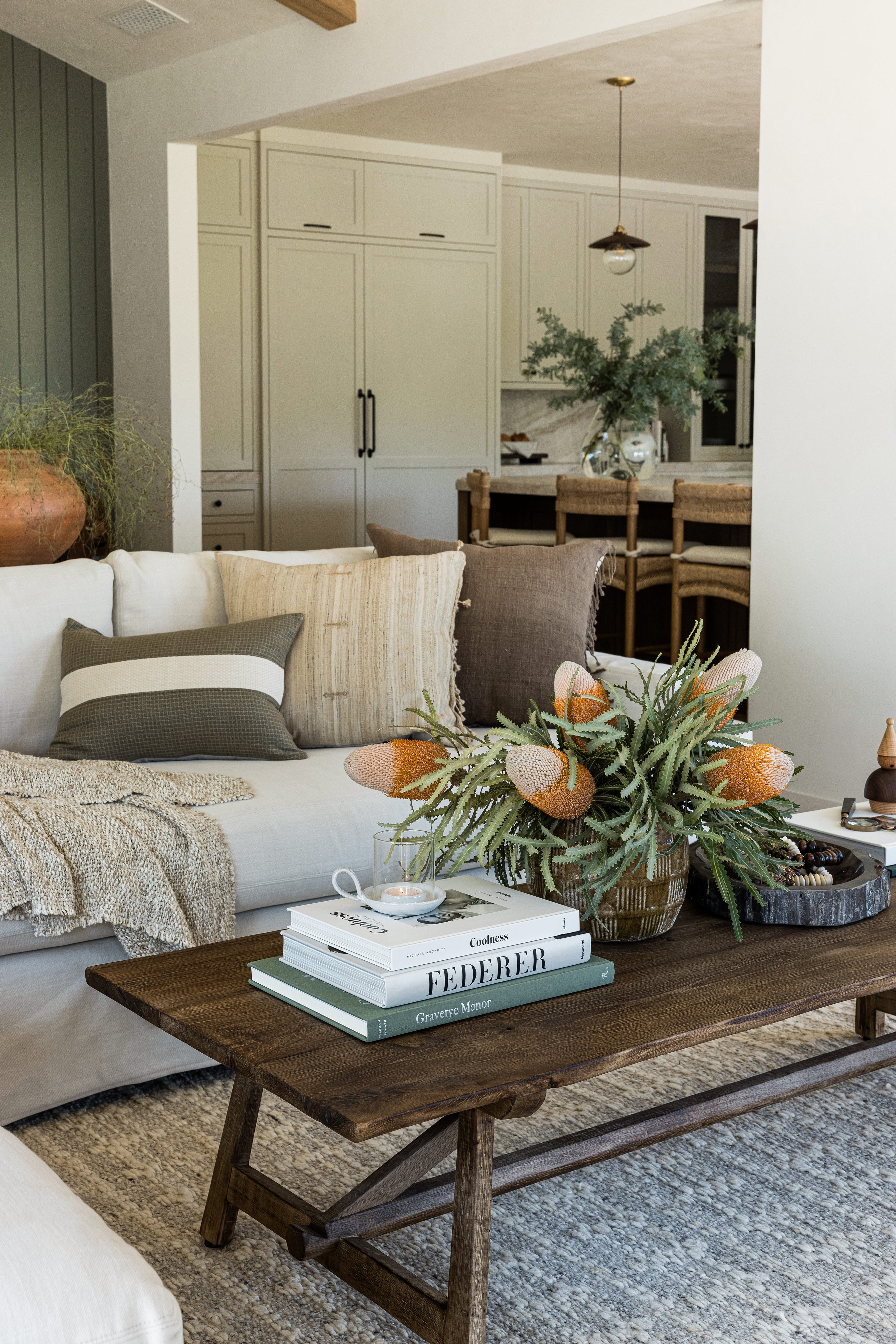 Living room with a coffee table, books, and decorative items.